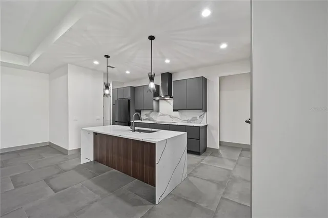 a view of a room with a sink and chandelier