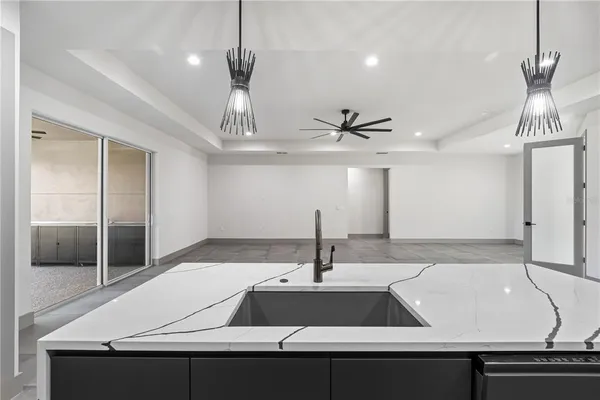 a kitchen with kitchen island a counter space a sink appliances and cabinets