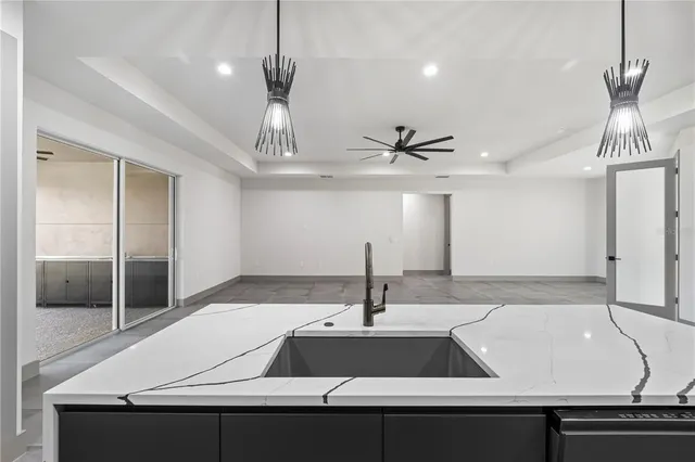 a kitchen with kitchen island a counter space a sink appliances and cabinets