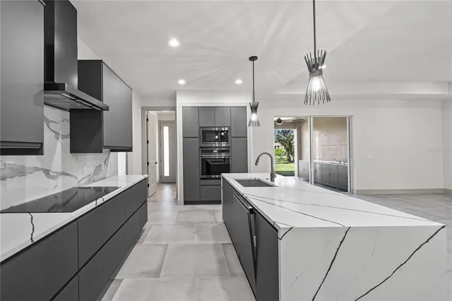 an empty room with windows and ceiling fan