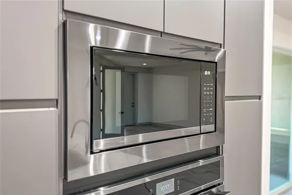 a view of a livingroom with a ceiling fan and window