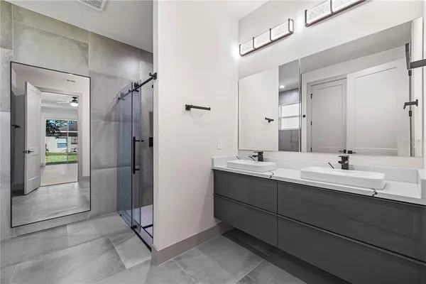 an empty room with wooden floor closet and windows