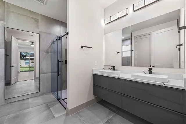 an empty room with wooden floor closet and windows