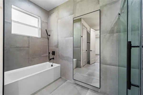 a bathroom with a shower sink and mirror