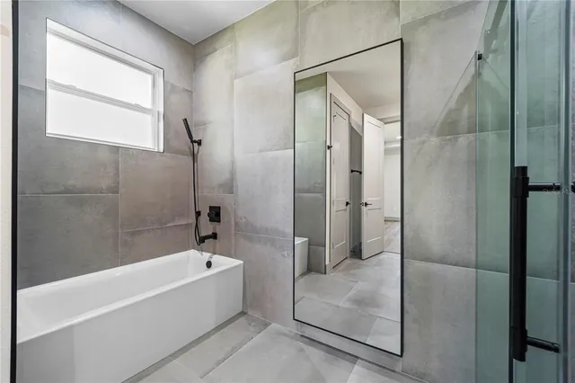 a bathroom with a shower sink and mirror