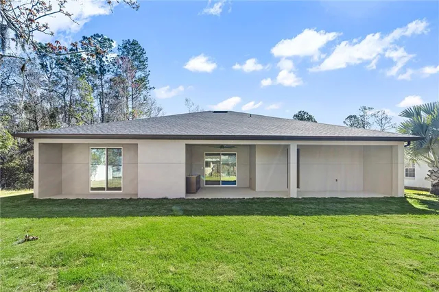 a front view of a house with a garden and yard