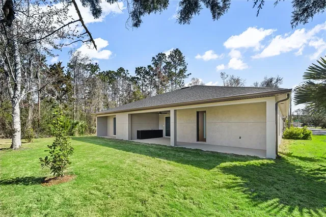 a view of a house with a backyard