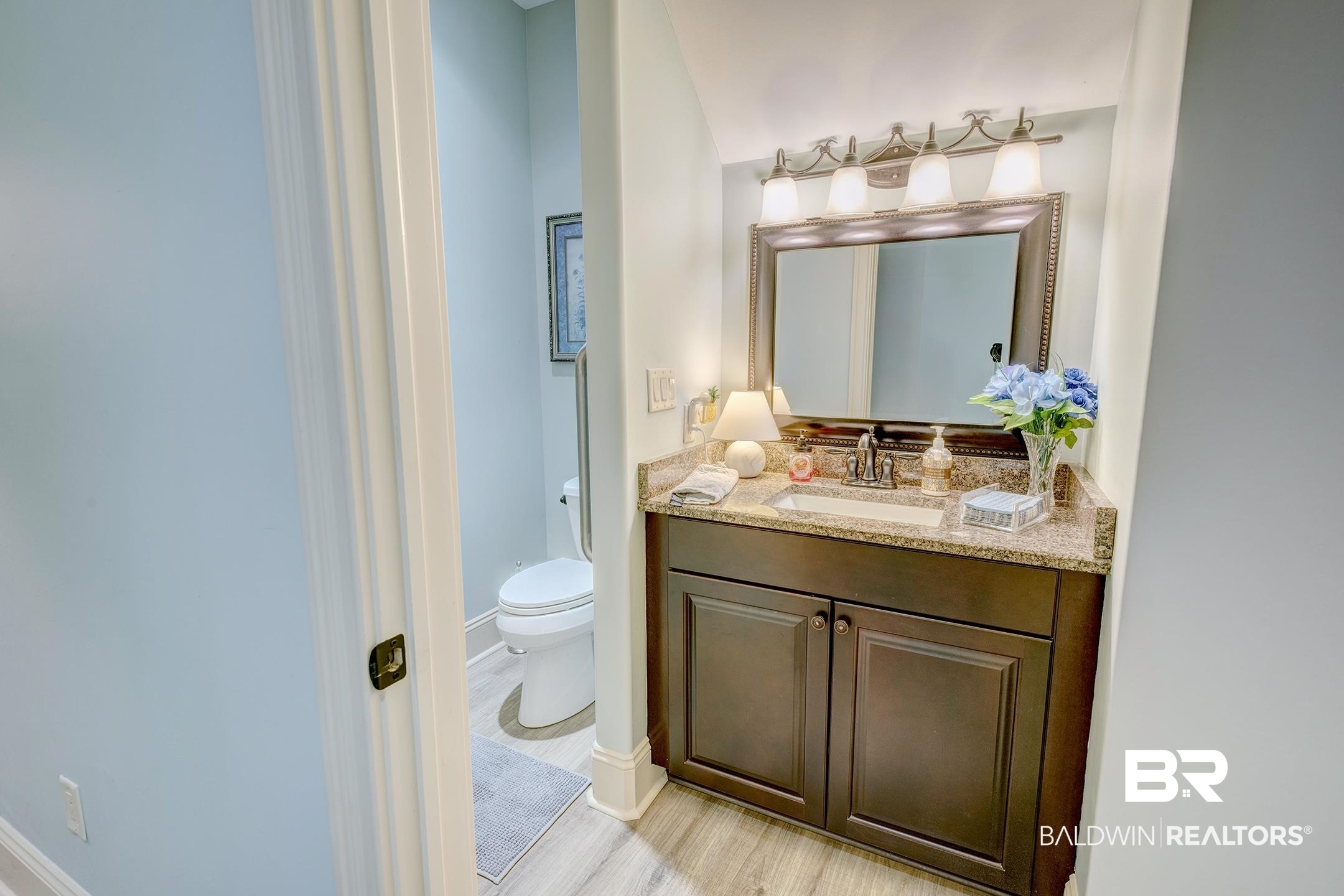 9357 Lakeview Drive Foley, AL 36535 - Photo 53 of 68 Bathroom vanity featuring a granite countertop, undermount sink, and dark wood cabinetry