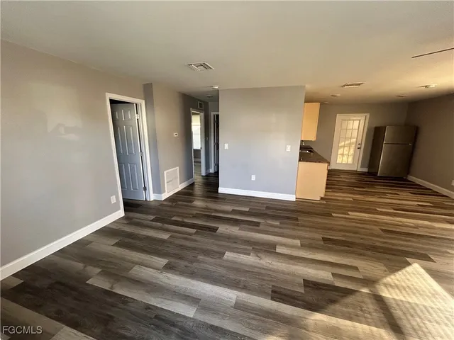 a view of a room with wooden floor and staircase
