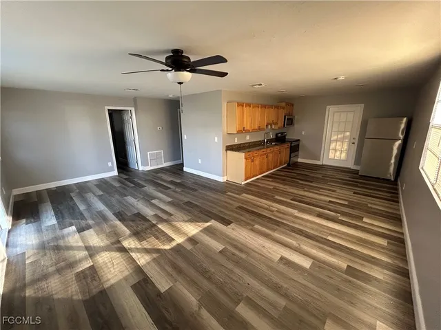 a view of an empty room and wooden floor
