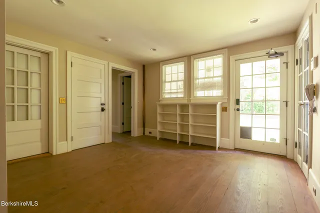 an empty room with a empty space & large window