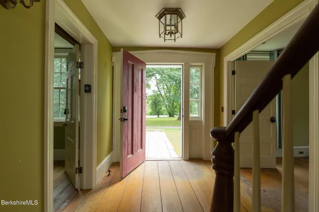 a view of entryway with wooden floor and stairs