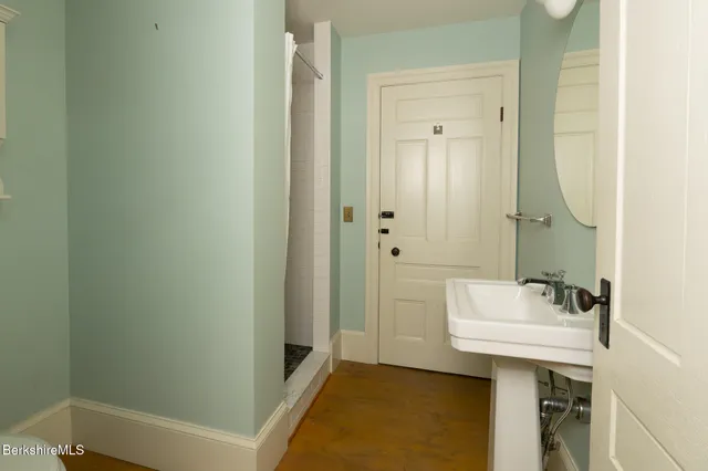 a bathroom with a sink a mirror and a bathtub
