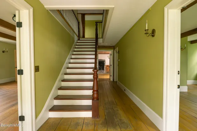 a view of a staircase with wooden floor and windows