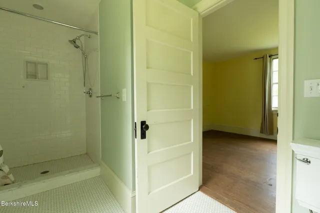 a bathroom with a shower and a glass door