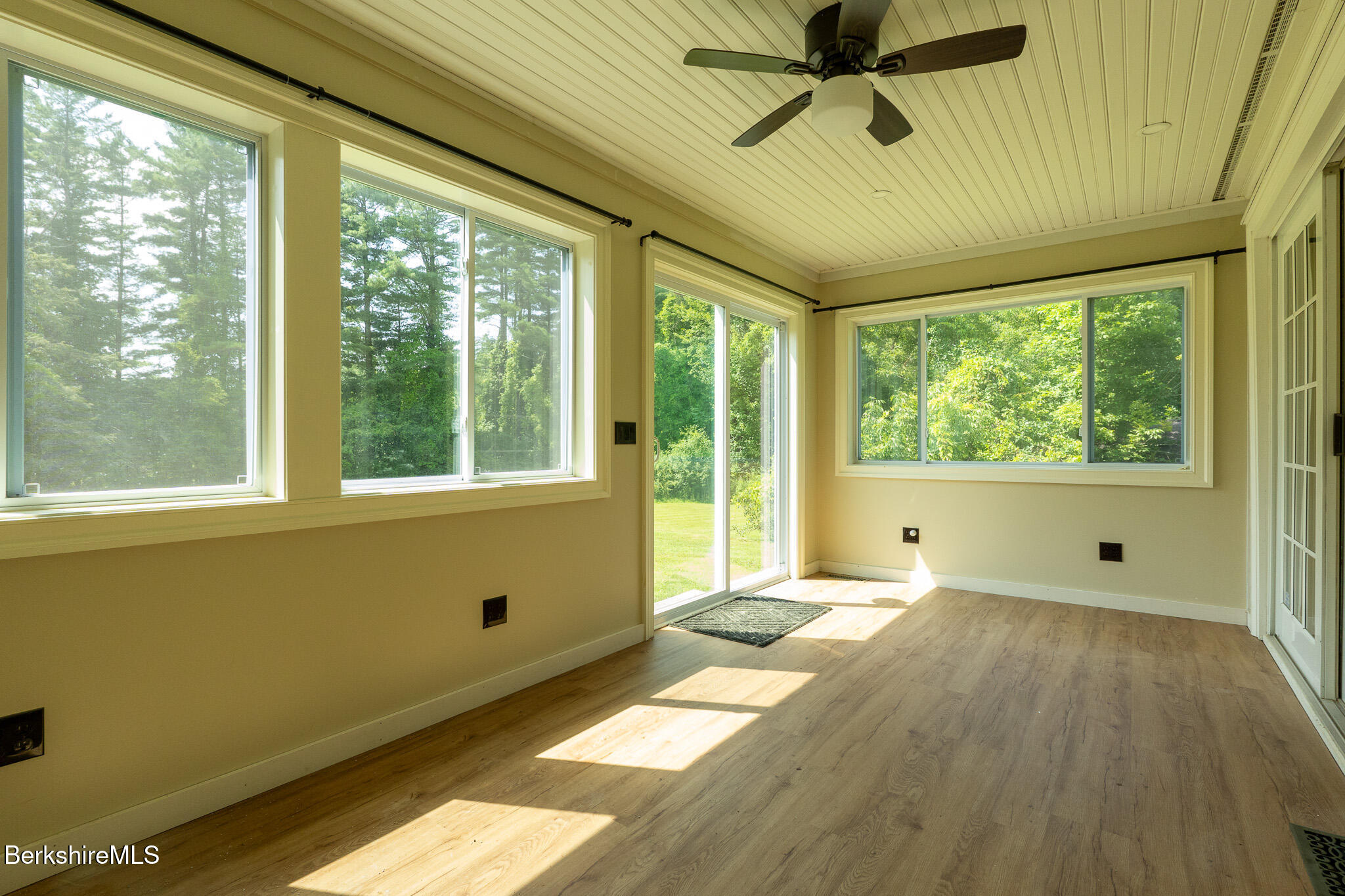 560 Stockbridge Road Lee, MA 01238 - Photo 44 of 48 a view of an empty room with a window and a ceiling fan