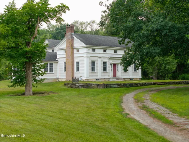 a view of a house with a yard patio and swimming pool
