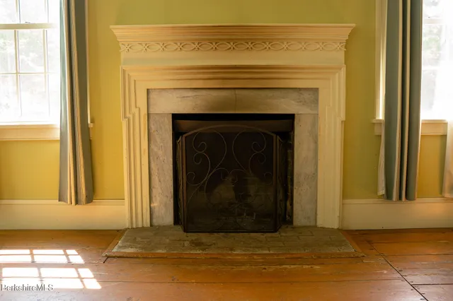a view of a livingroom with a fireplace and a window