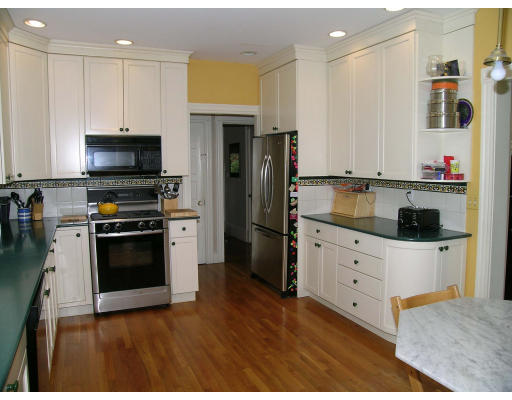 180 Clark Road Brookline, MA 02445 - Photo 8 of 12 a kitchen with granite countertop white cabinets and stainless steel appliances