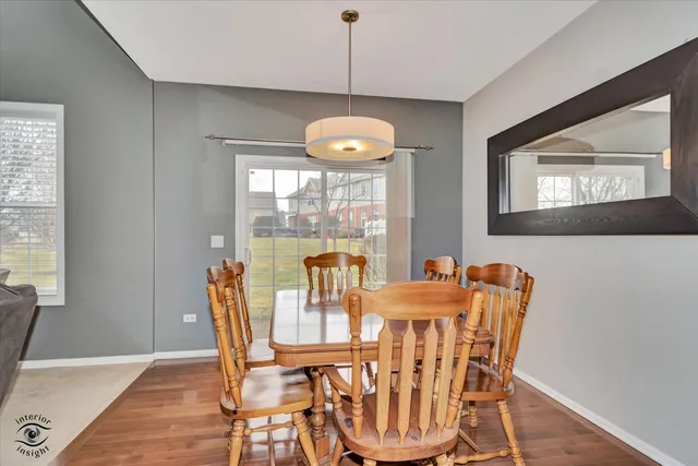 a view of a dining room with furniture wooden floor and chandelier