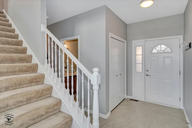 a view of staircase with lots of frames on wall
