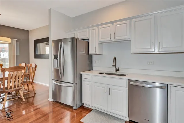 a kitchen with stainless steel appliances a refrigerator sink and cabinets
