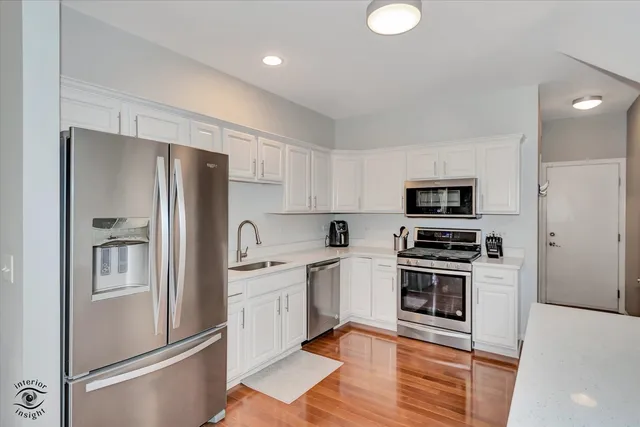 a kitchen with stainless steel appliances a refrigerator sink and stove