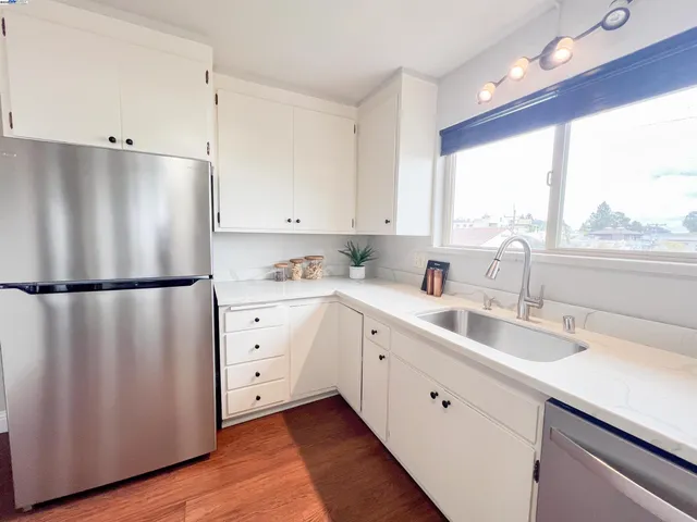 a kitchen with stainless steel appliances a stove top oven