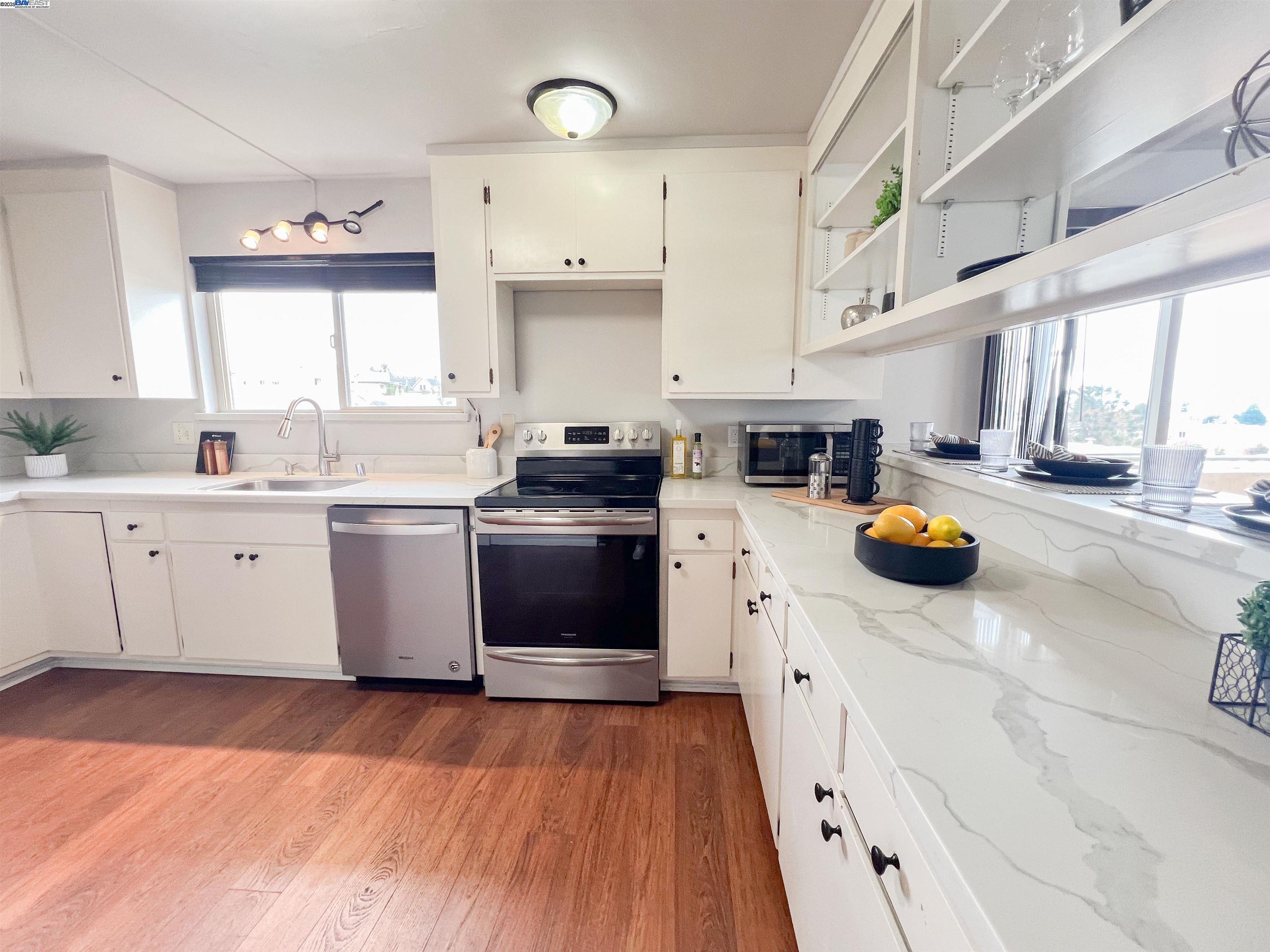 1444 Walnut Street Berkeley, CA 94709 - Photo 13 of 58 a kitchen with stainless steel appliances a stove top oven