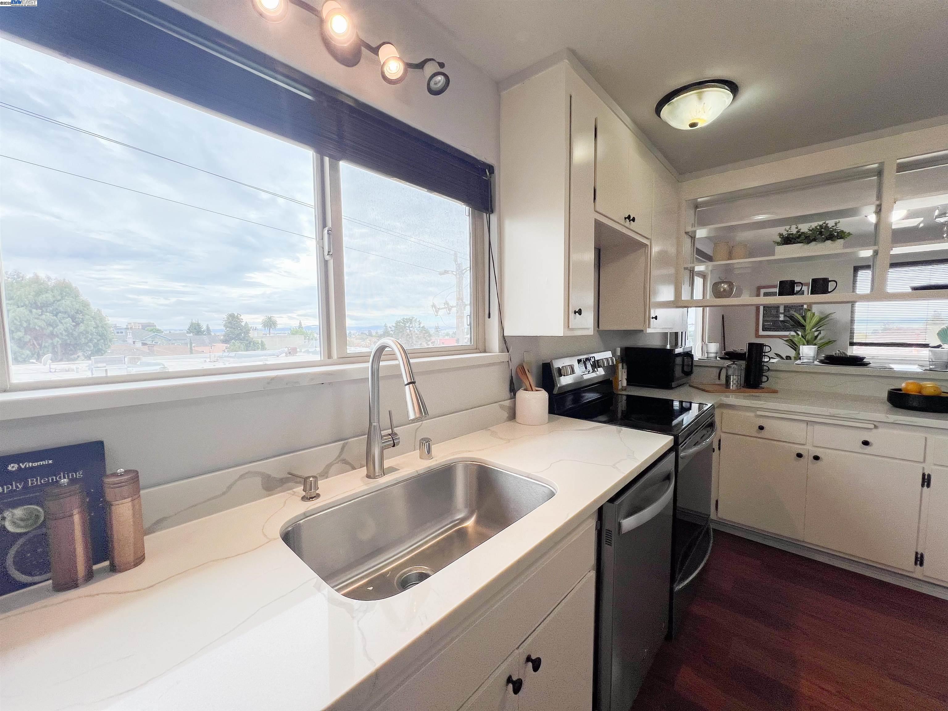 1444 Walnut Street Berkeley, CA 94709 - Photo 14 of 58 a kitchen that has a sink a stove and a wooden floor