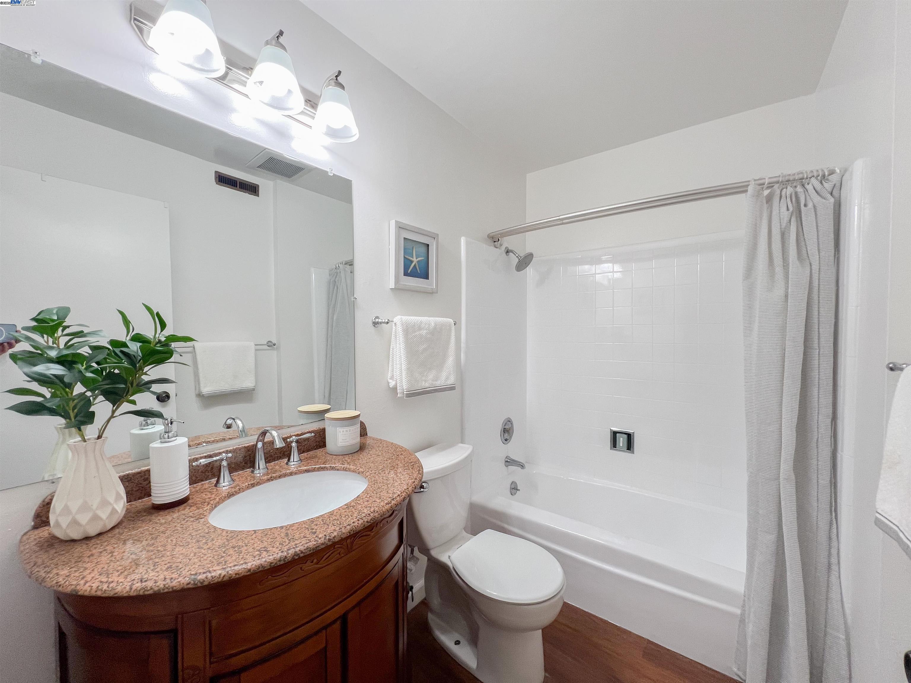 1444 Walnut Street Berkeley, CA 94709 - Photo 15 of 58 a bathroom with a granite countertop sink a toilet and shower