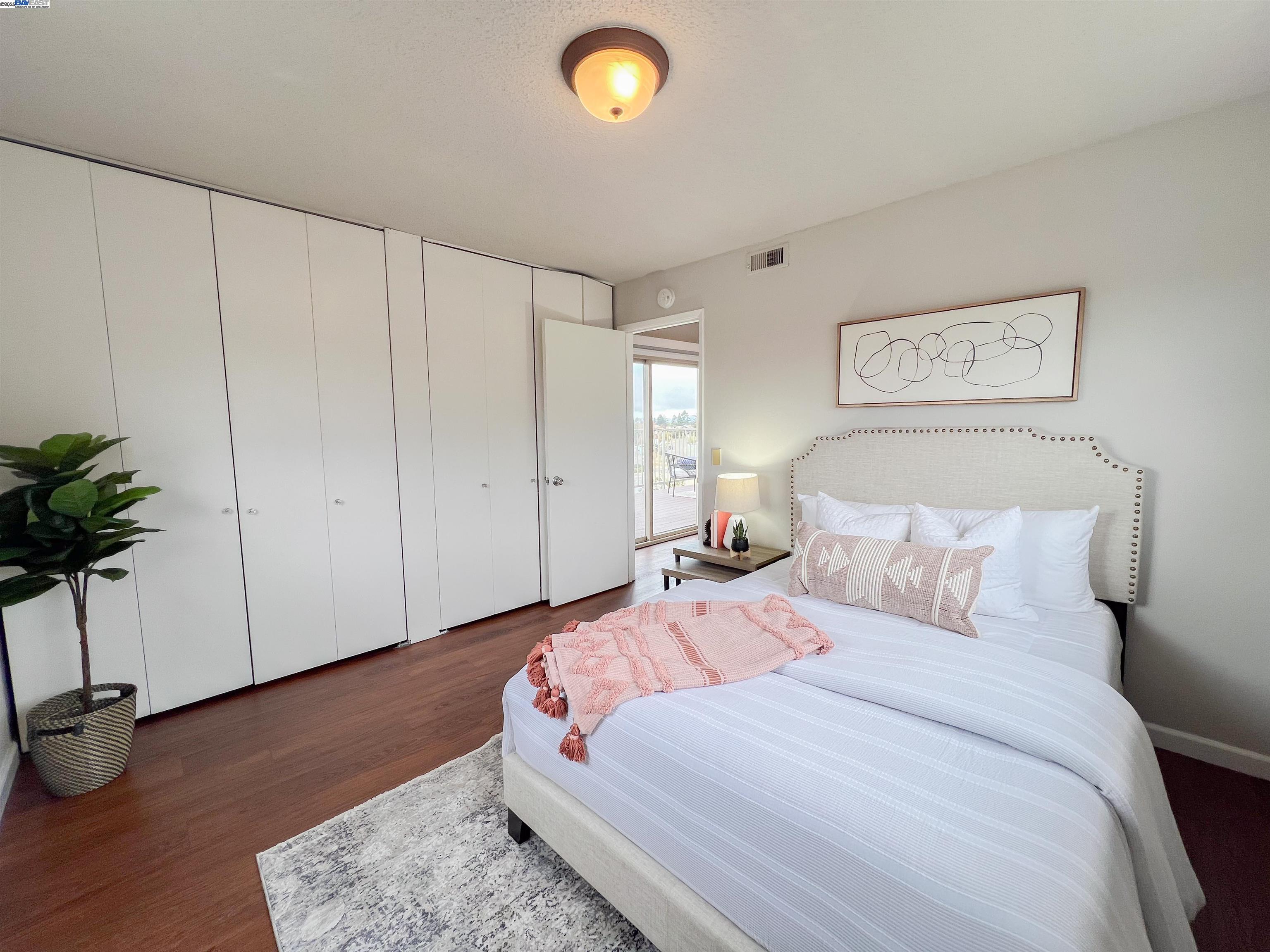 1444 Walnut Street Berkeley, CA 94709 - Photo 17 of 58 a bedroom with a bed and a potted plant