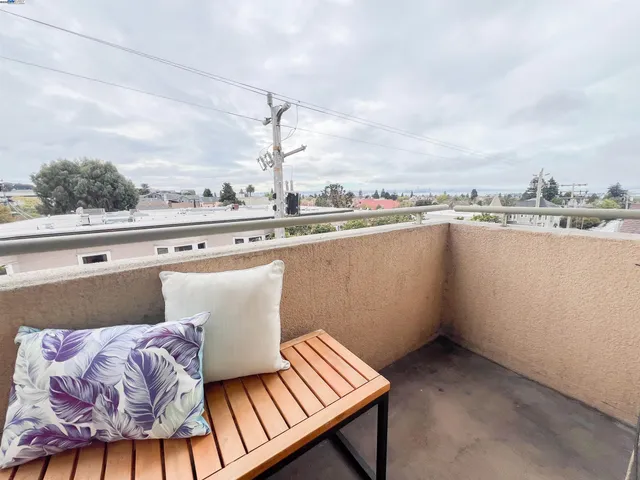 a view of a balcony with wooden floor