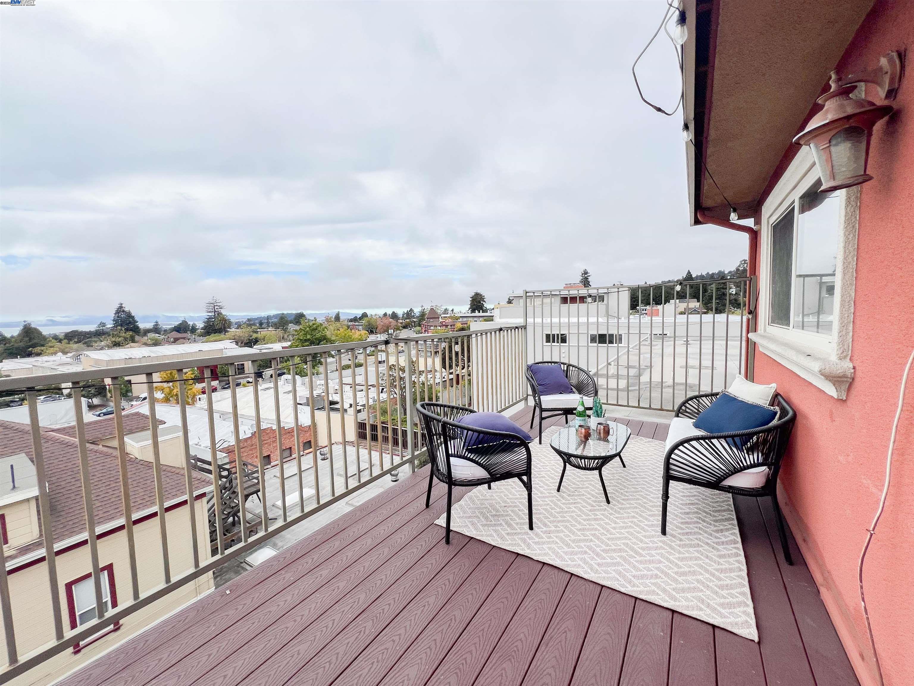 1444 Walnut Street Berkeley, CA 94709 - Photo 22 of 58 a balcony with wooden floor table and chairs