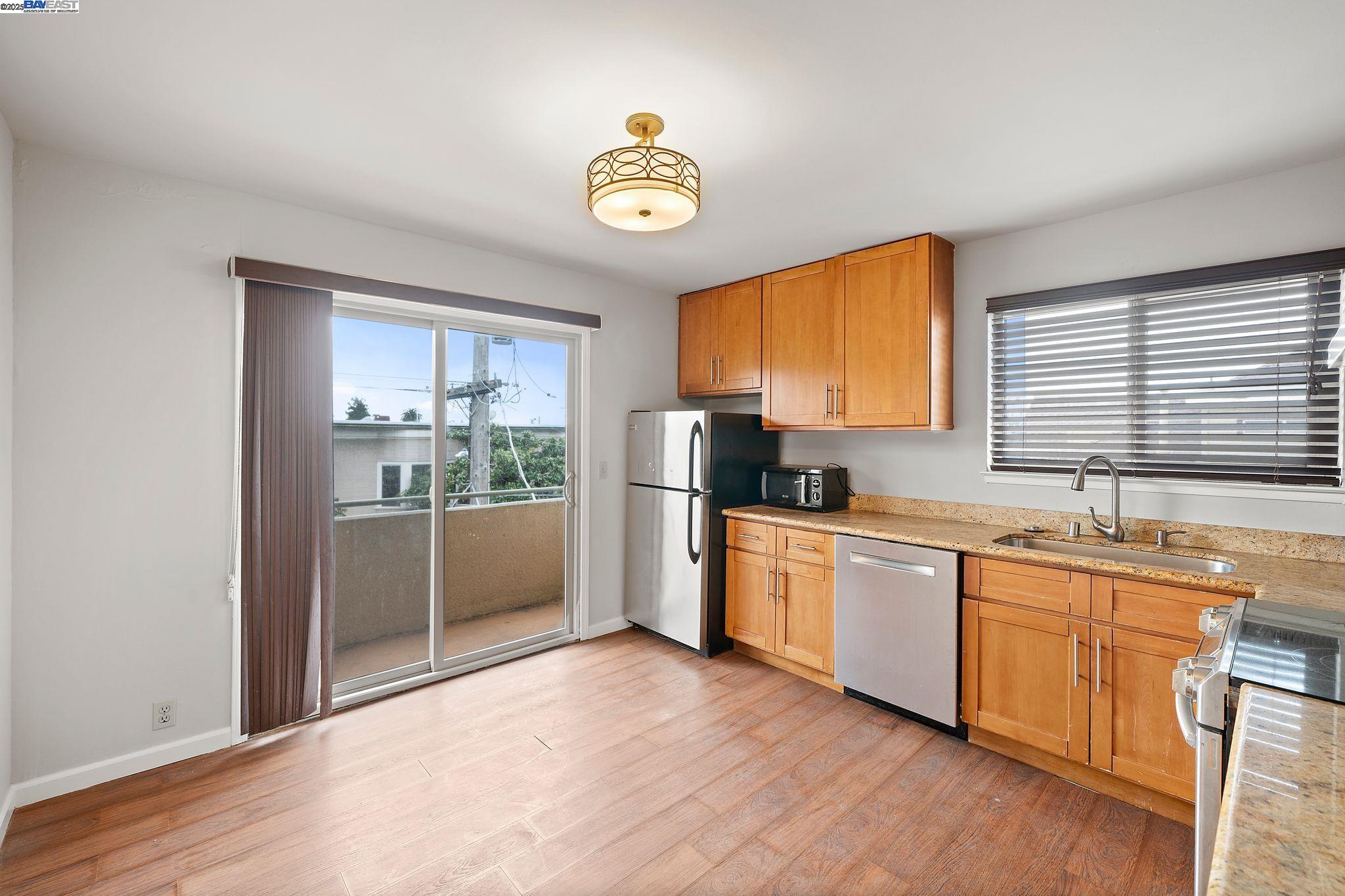 1444 Walnut Street Berkeley, CA 94709 - Photo 33 of 58 a kitchen with stainless steel appliances granite countertop a stove a sink and a refrigerator
