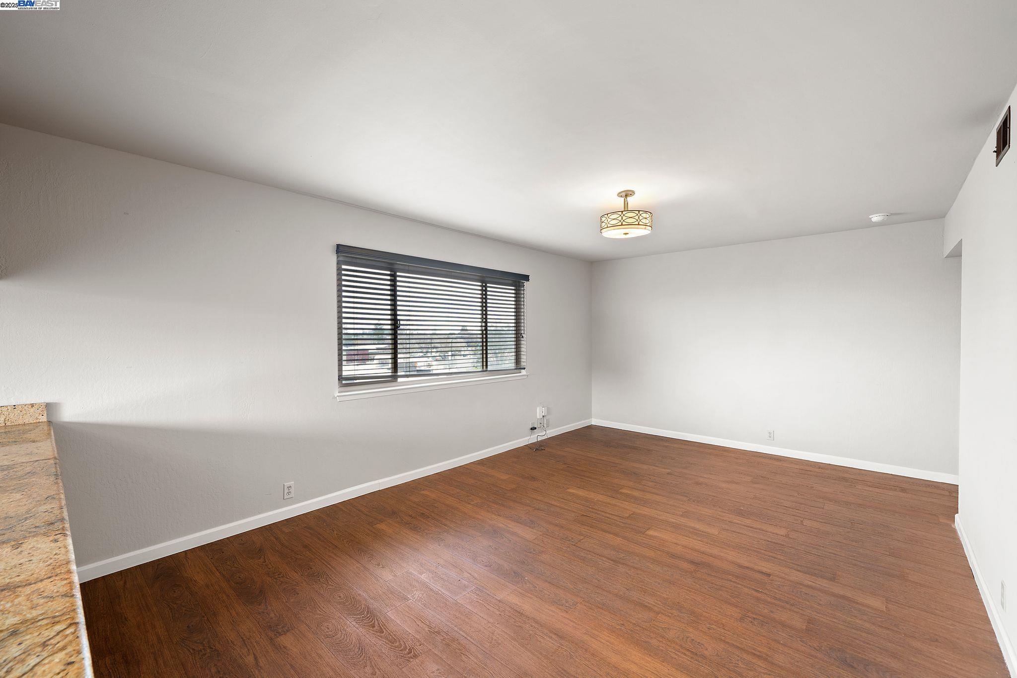 1444 Walnut Street Berkeley, CA 94709 - Photo 37 of 58 a view of an empty room with window and wooden floor