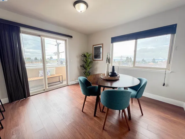 a view of a dining room with furniture and wooden floor