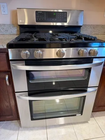 a stove top oven sitting inside of a kitchen