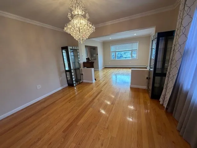 a view of a room with wooden floor and staircase