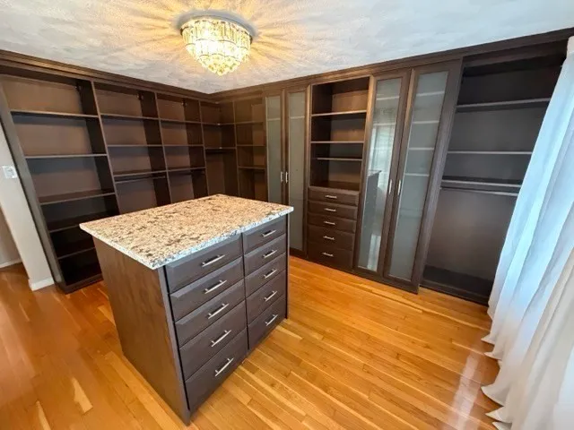 a kitchen with a wooden floor and a cabinet