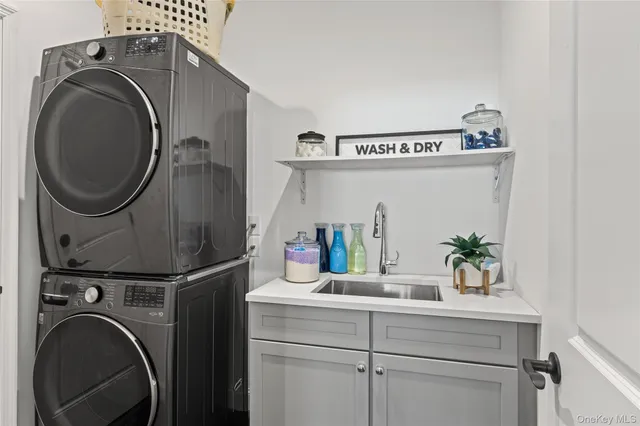 a utility room with sink dryer and washer