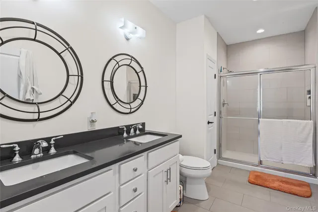 a bathroom with a double vanity sink and a mirror