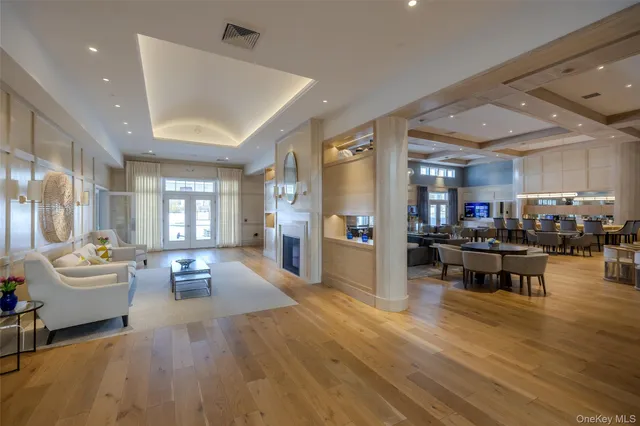 a living room with furniture a rug and a chandelier