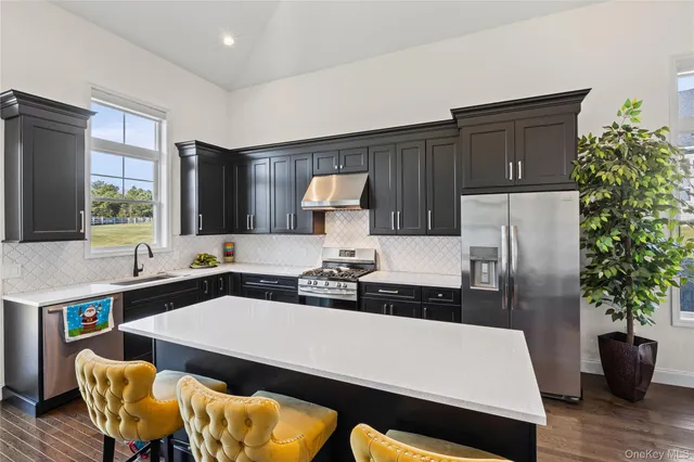 a kitchen with a table chairs and refrigerator