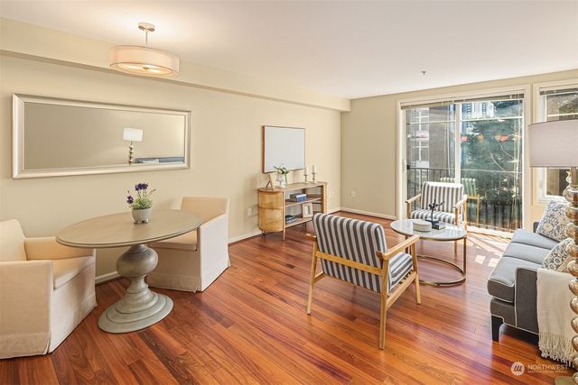 a living room with furniture a wooden floor and a sink
