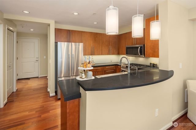 a kitchen with stainless steel appliances a sink a stove and a refrigerator