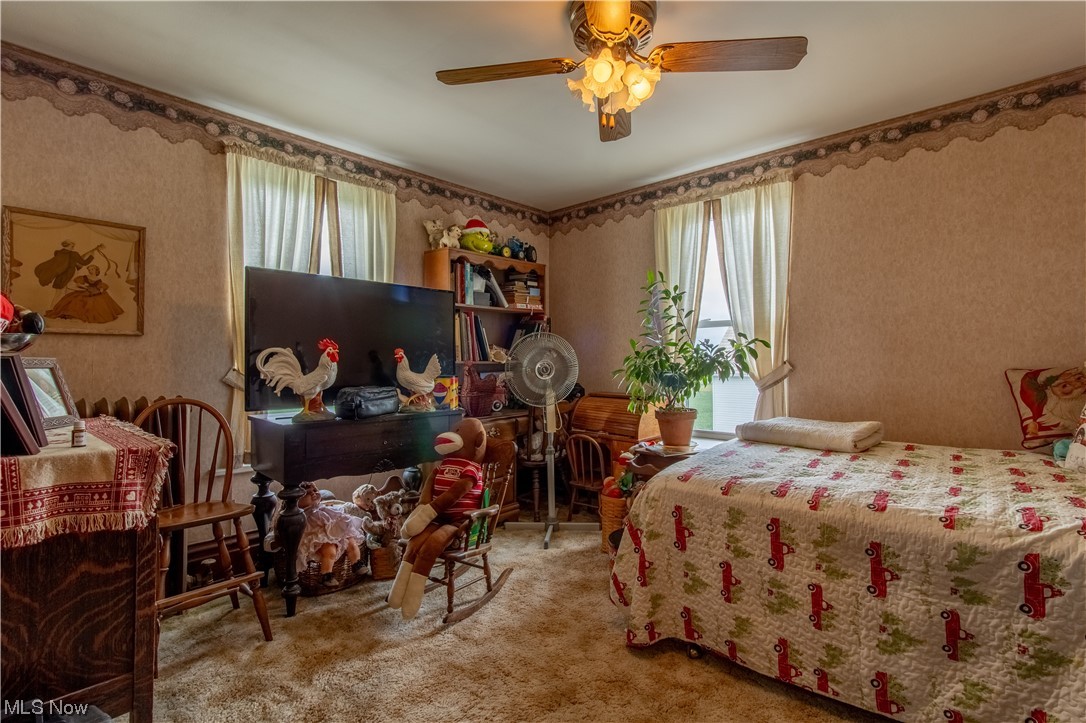 18752 Courtney Road Beloit, OH 44609 - Photo 19 of 23 Bedroom featuring ceiling fan, multiple windows, and carpet flooring