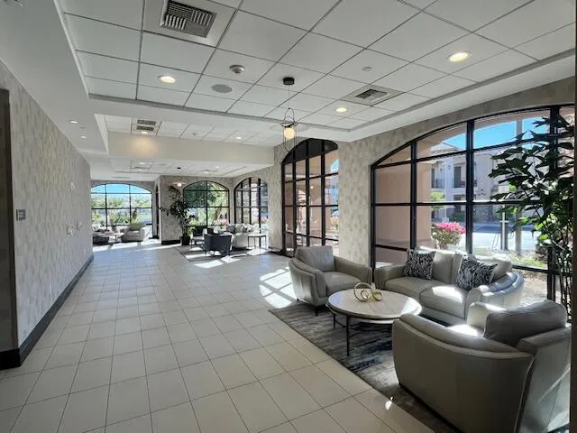 a living room with lots of furniture and kitchen view