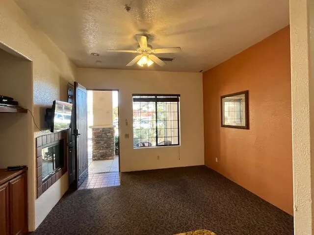 a kitchen with kitchen island granite countertop wooden cabinets a refrigerator and a sink