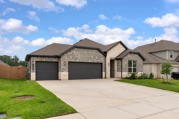 a front view of a house with a garden and yard
